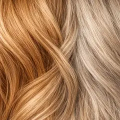 Cheveux orange : comment rattraper ce look ? Deux mèches contrastées, l'une cuivrée, l'autre blonde cendrée, se croisent.