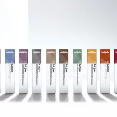 Dix tubes de coloration Majirel L'Oréal, aux teintes variées, prêts pour un temps de pause parfait.