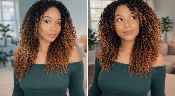 Une femme aux cheveux bouclés et dégradés, une coiffure qui tient plusieurs jours, souriant.