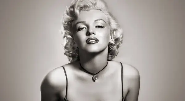 Icône glamour avec une coiffure année 50, maquillage marqué et un collier en forme de cœur.