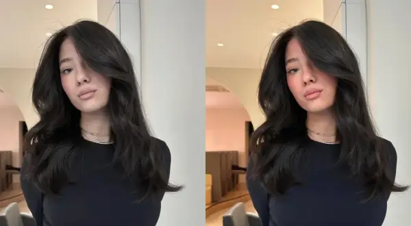 Une jeune femme aux cheveux bruns et ondulés, un look brillant et soigné. Ce style, c'est ce qu'est un gloss en coiffure : une touche d'éclat pour sublimer la chevelure.