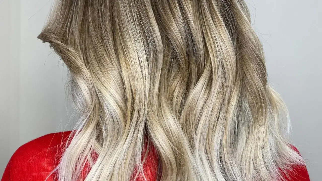 Magnifique coloration sur cheveux décolorés, avec des reflets blonds naturels et une texture wavy.