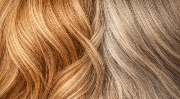 Cheveux orange : comment rattraper ce look ? Deux mèches contrastées, l'une cuivrée, l'autre blonde cendrée, se croisent.